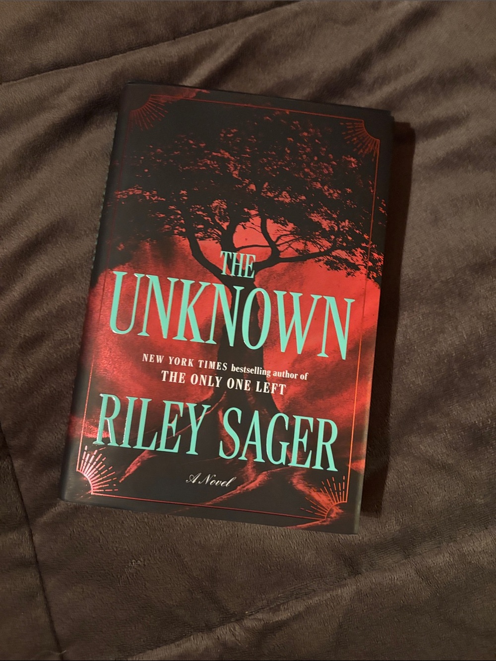 The Unknown by Riley Sager - Red Hardcover Novel